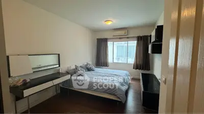 Cozy bedroom with modern furnishings and natural light