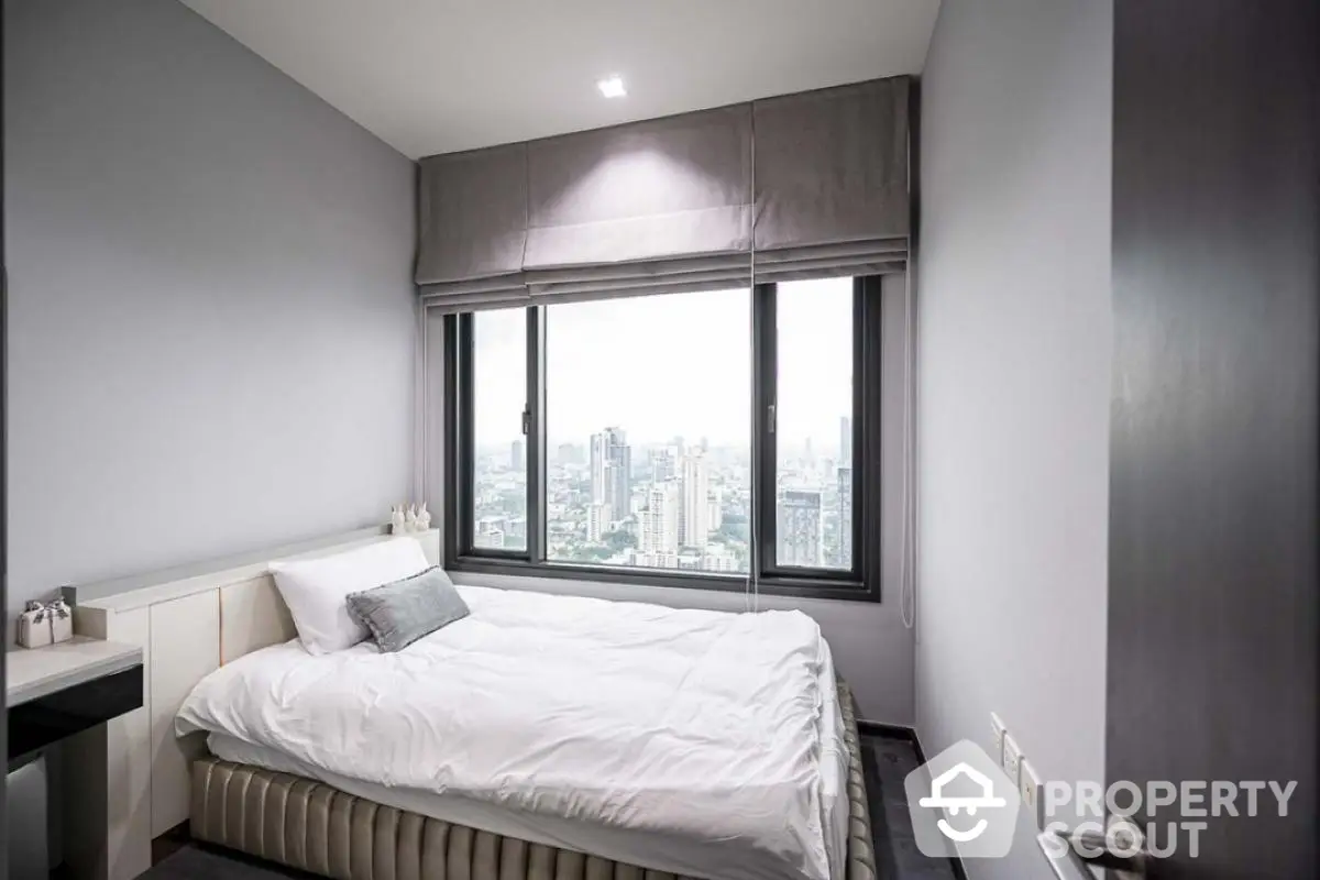 Modern bedroom with city view in high-rise apartment