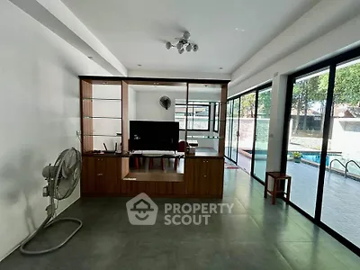 Spacious living room with pool view and modern decor