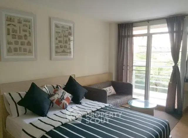 Modern bedroom with balcony access and stylish decor in a cozy apartment.