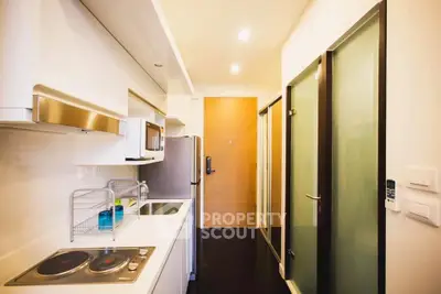 Modern kitchen with sleek appliances and minimalist design in a compact space.