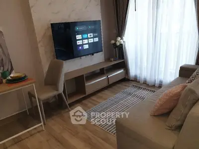 Modern living room with wall-mounted TV and cozy seating area