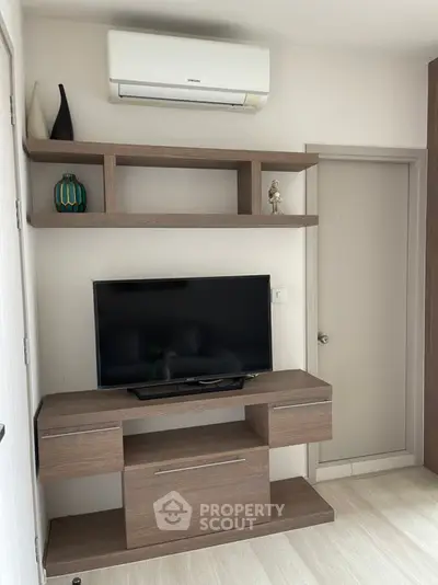Modern living room with sleek TV stand and air conditioning unit