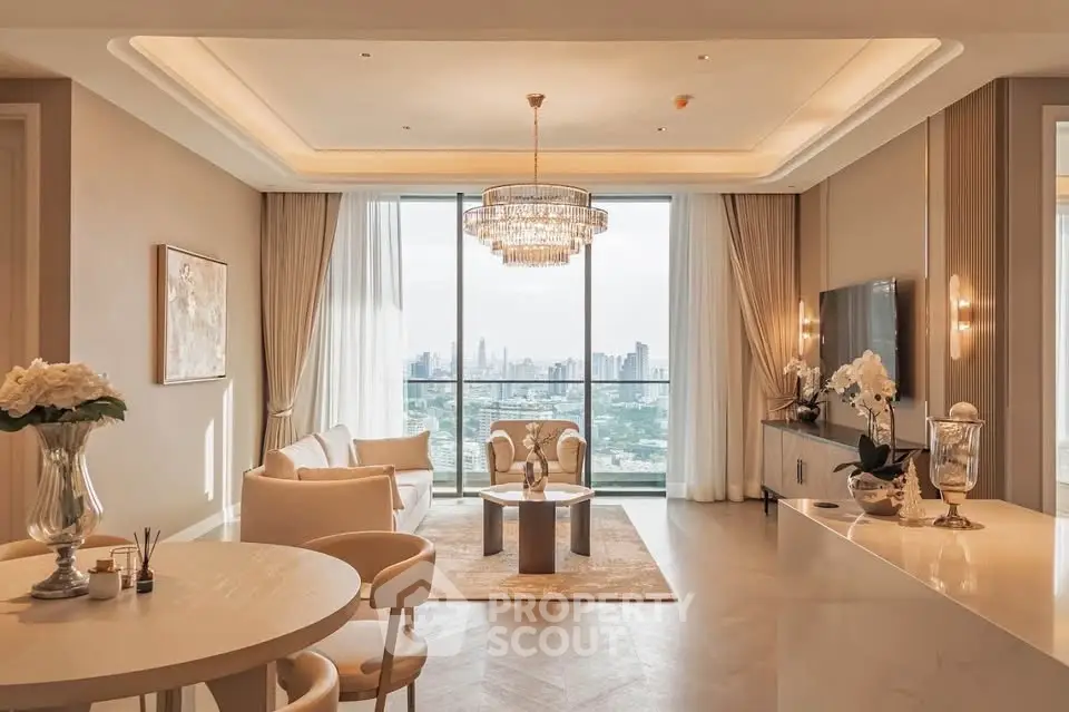 Luxurious living room with elegant chandelier and stunning city view, featuring modern decor and spacious layout.