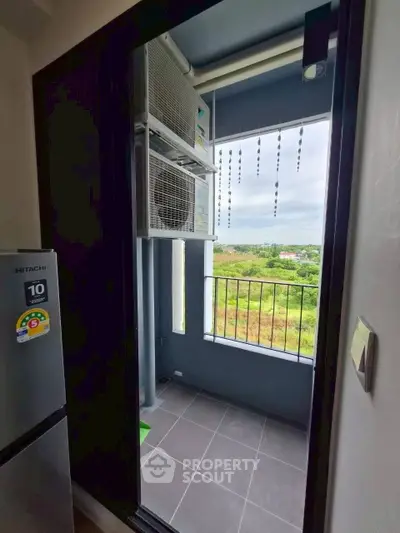Charming balcony with scenic view and modern appliances, perfect for relaxation and enjoying the outdoors.