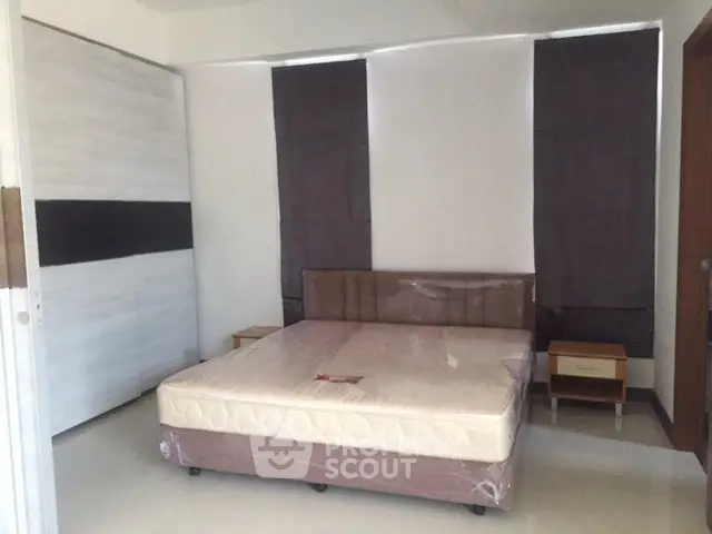 Modern bedroom with minimalist design and large bed in a stylish apartment.