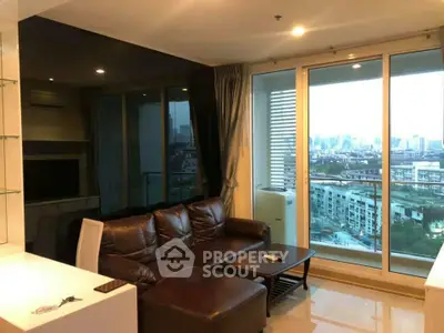 Modern living room with leather sofa and city view from large windows