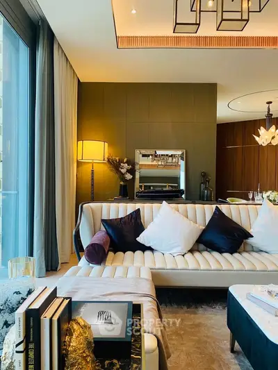 Luxurious living room with elegant decor and large windows offering natural light.