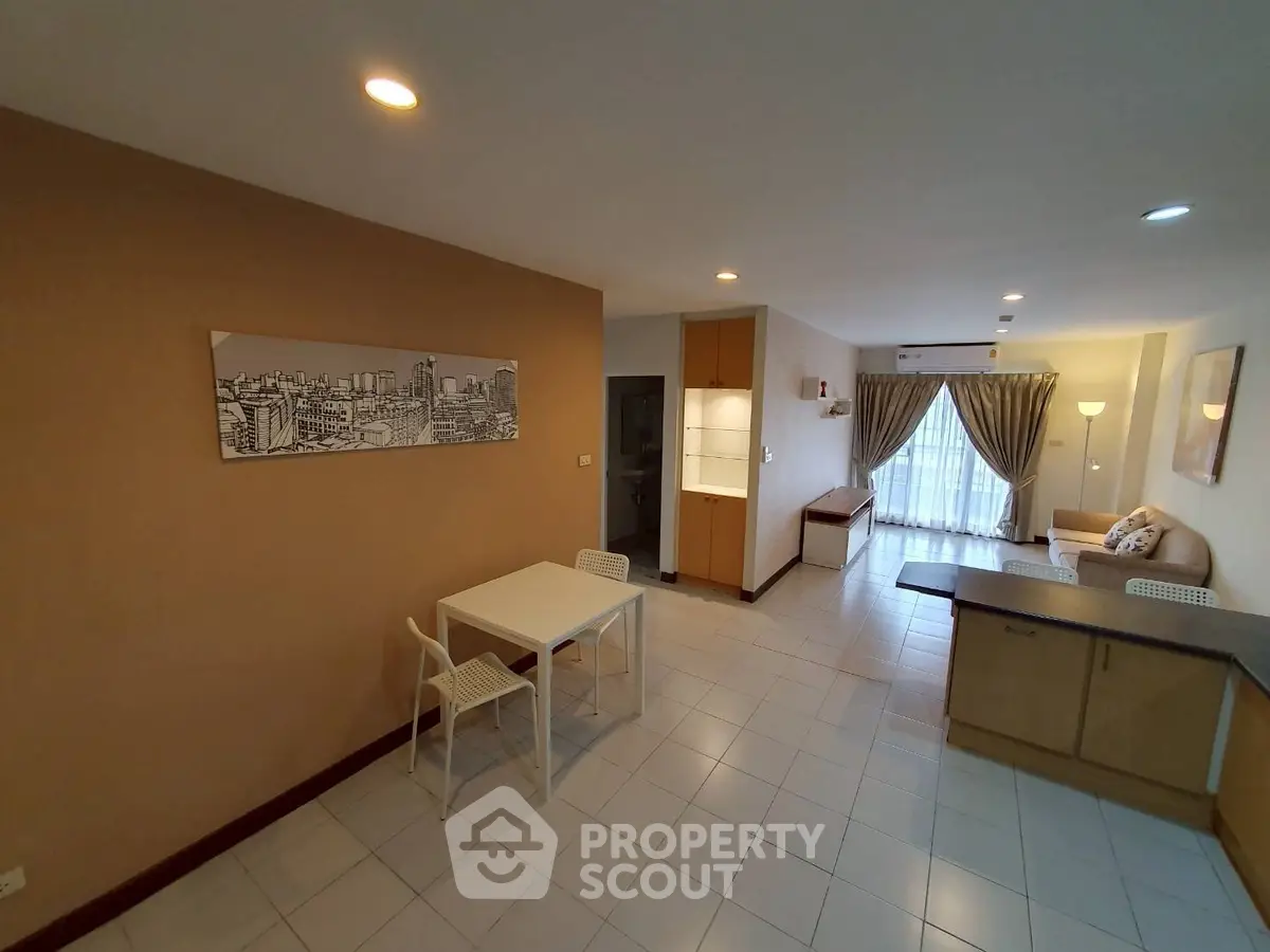 Spacious open-plan living room with modern decor and ample natural light.