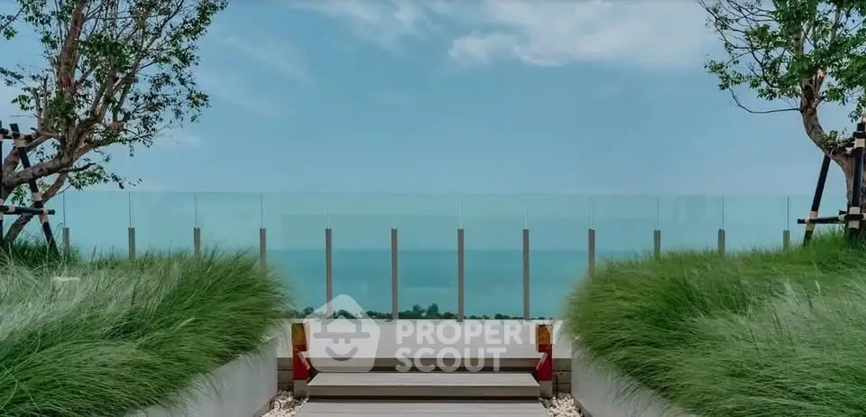 Stunning rooftop view with lush greenery and ocean backdrop