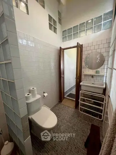 Charming bathroom with modern fixtures and stylish tile design, perfect for a cozy home.