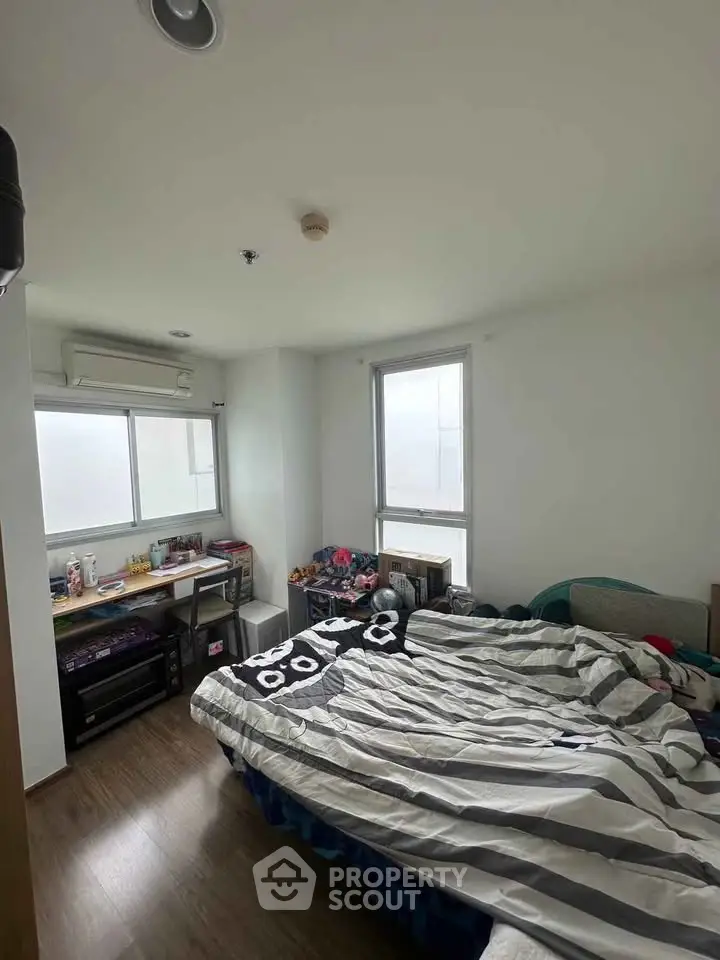 Cozy bedroom with modern decor and ample natural light