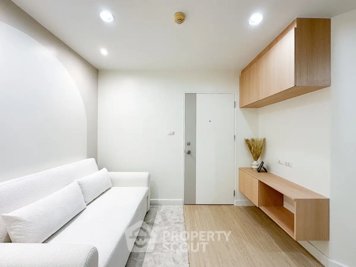 Modern minimalist living room with white sofa and wooden accents