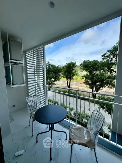 Charming balcony with seating and scenic view, perfect for relaxation.