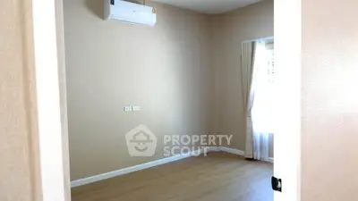 Minimalist empty room with air conditioning and wooden flooring, perfect for customization.