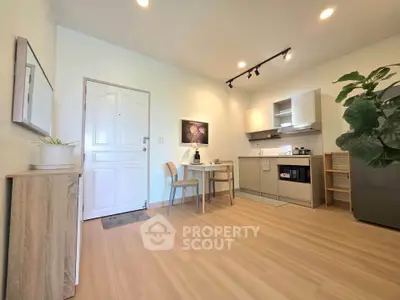Modern kitchen with open layout and sleek appliances in a cozy apartment setting.