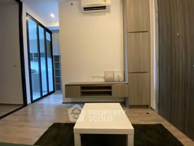 Modern living room with sleek design and built-in storage in a stylish apartment.