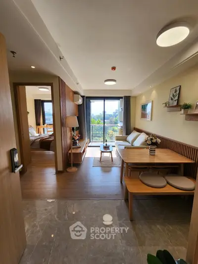 Modern open-plan living room with dining area and natural light