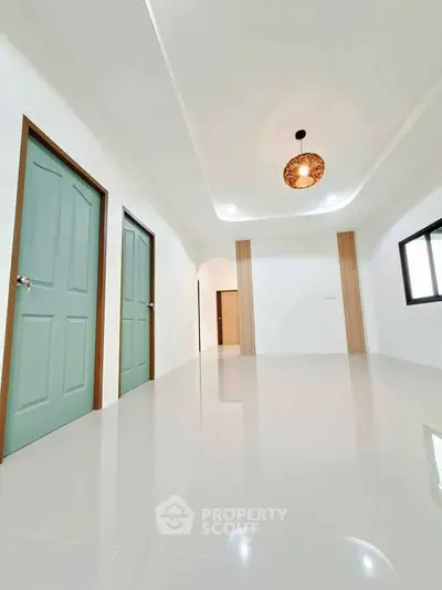 Spacious modern interior with glossy floors and stylish lighting, perfect for contemporary living.