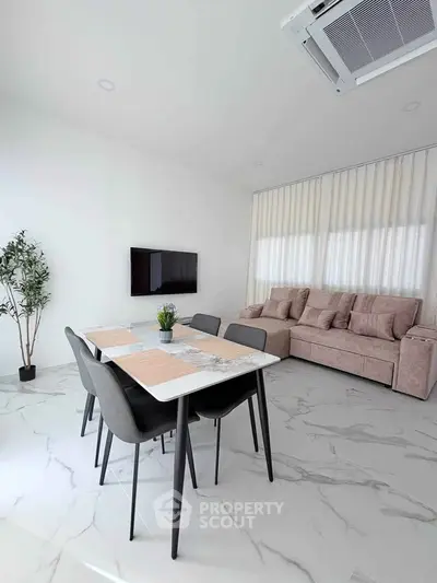 Modern living room with sleek dining area and stylish decor