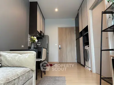 Modern apartment interior with stylish kitchen and cozy living area, featuring sleek appliances and elegant decor.