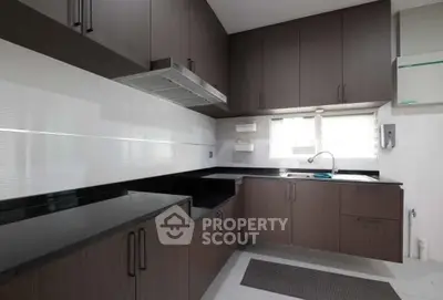 Modern kitchen with sleek dark cabinets and black countertops