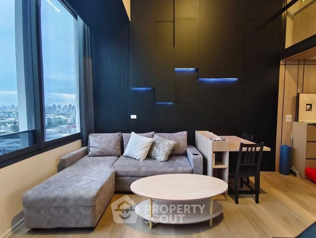 Modern living room with city view, stylish furniture, and sleek design in a high-rise apartment.