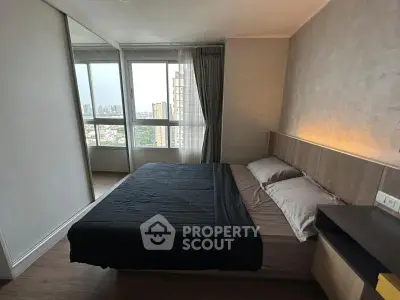 Modern bedroom with city view, featuring sleek design and large windows for natural light.