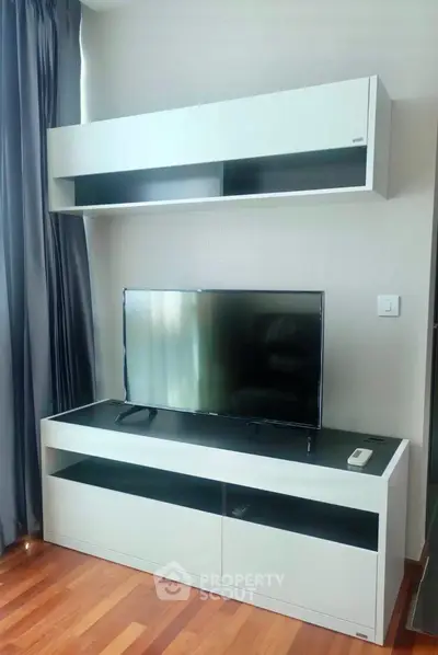 Modern living room with sleek TV unit and hardwood floors