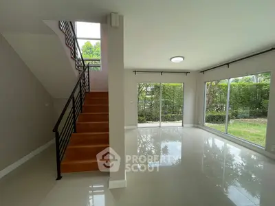 Spacious modern living room with large windows and garden view