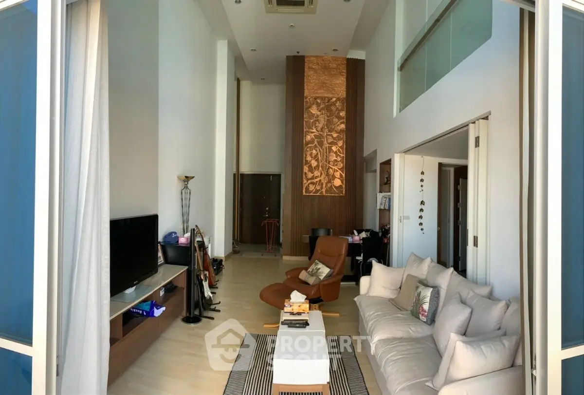 Spacious modern living room with high ceilings and elegant decor