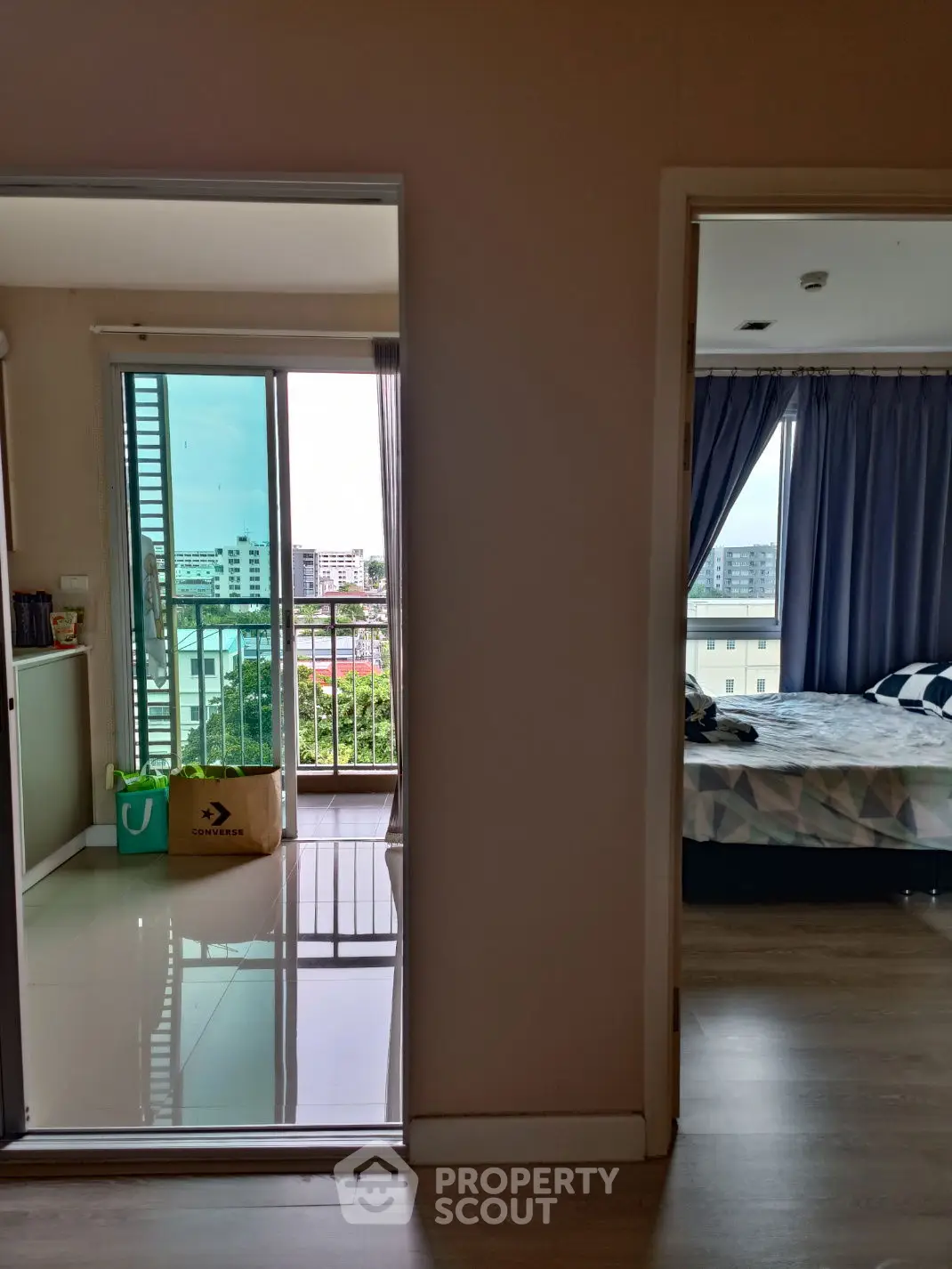 Modern apartment with balcony and bedroom offering city views
