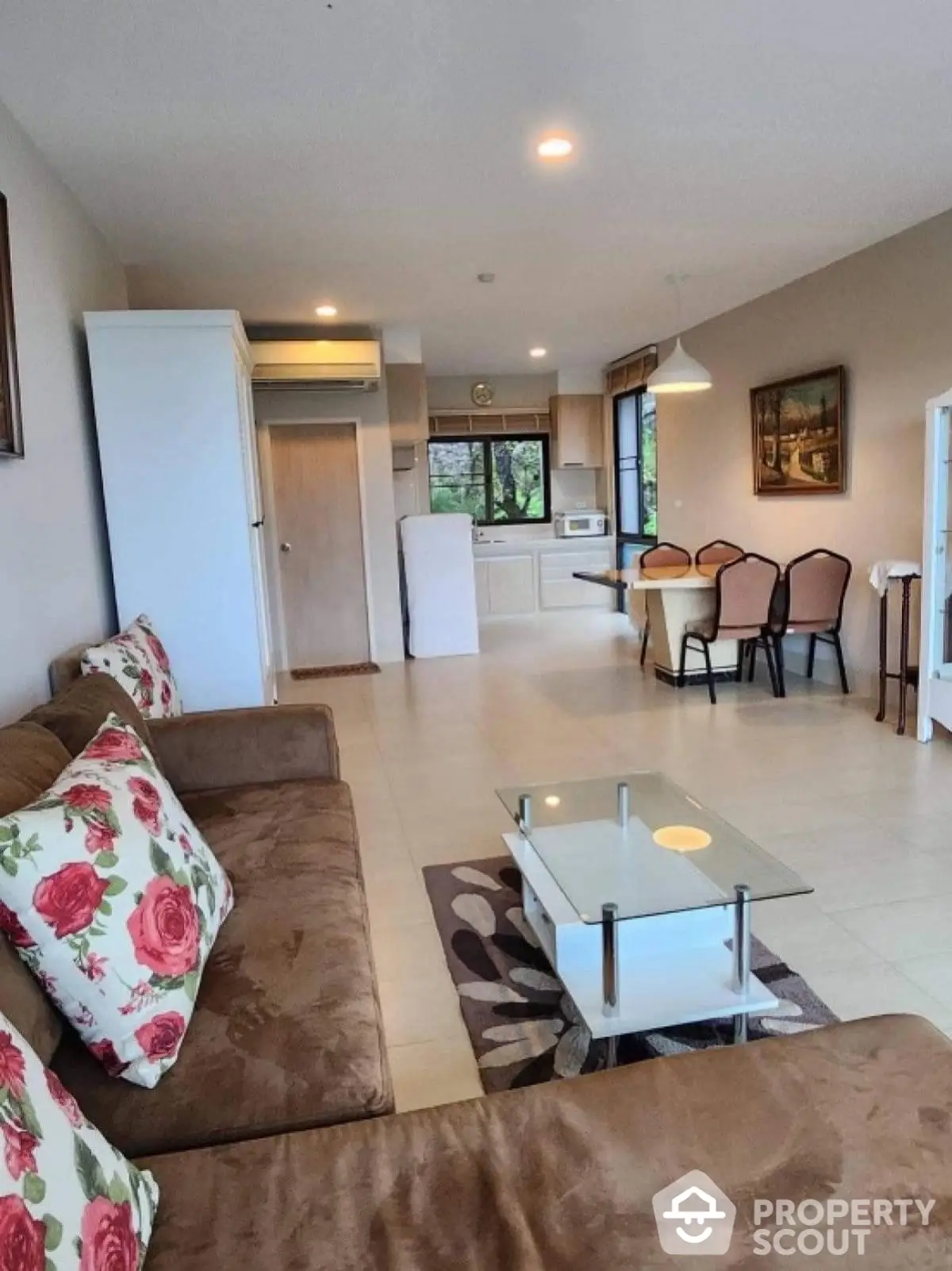 Spacious open-plan living room with modern furniture and dining area, perfect for family gatherings.