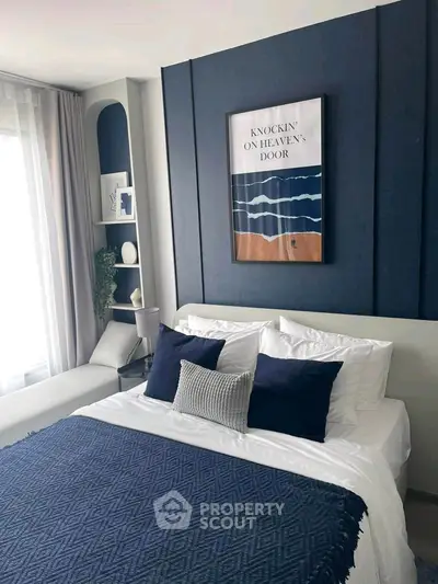 Stylish bedroom with modern decor and cozy bedding in a contemporary apartment.
