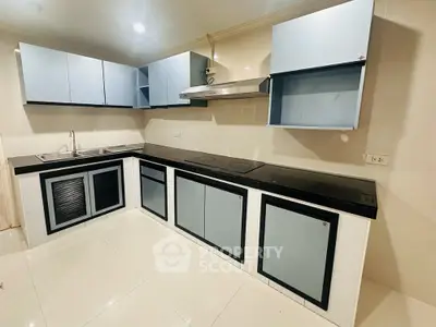 Modern kitchen with sleek cabinetry and electric cooktop in a stylish home