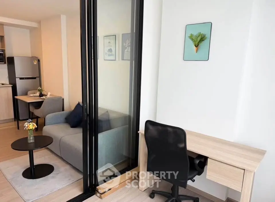 Modern apartment interior with cozy living room and study area, featuring sleek furniture and stylish decor.