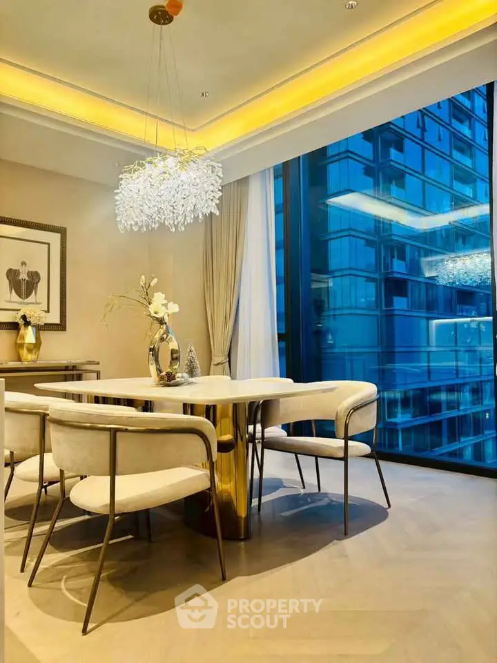 Luxurious dining area with elegant chandelier and city view, perfect for sophisticated urban living.