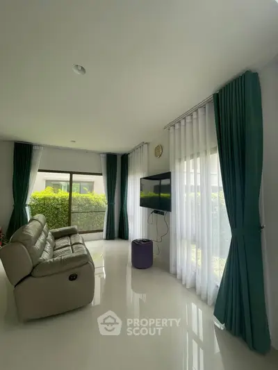 Spacious living room with modern decor and large windows for natural light