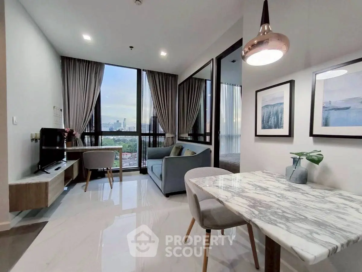 Modern living room with city view, elegant marble dining table, and cozy seating area.