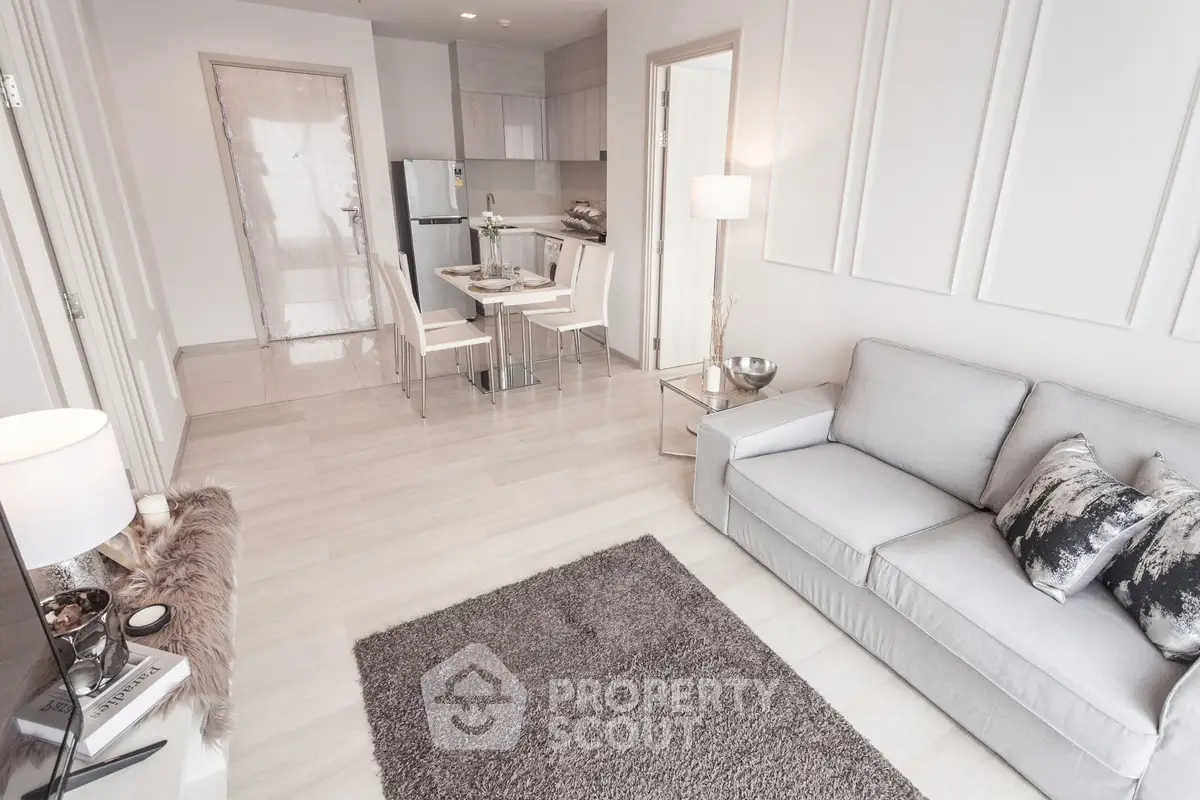 Modern living room with elegant decor and open kitchen layout in a stylish apartment.