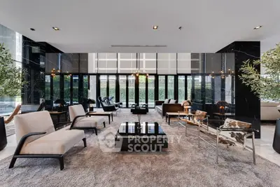 Luxurious modern living room with elegant furniture and floor-to-ceiling windows.