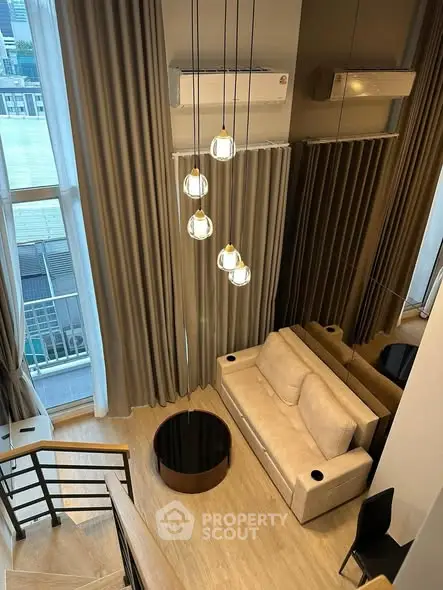 Modern loft-style living room with high ceilings and elegant lighting in a chic urban apartment.