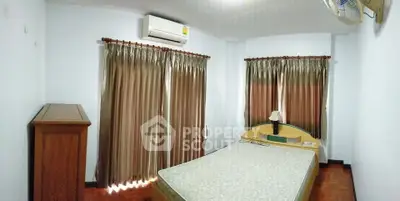 Cozy bedroom with air conditioning and elegant curtains, perfect for restful nights.