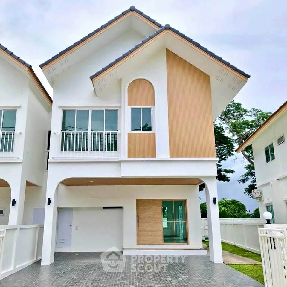 Modern two-story house with unique architectural design and spacious driveway.