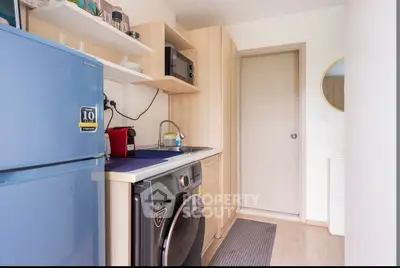 Compact kitchen with modern appliances and sleek wooden cabinetry