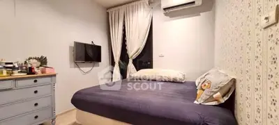 Cozy bedroom with modern decor and air conditioning, perfect for relaxation.