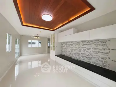 Modern living room with stylish ceiling and sleek built-in storage