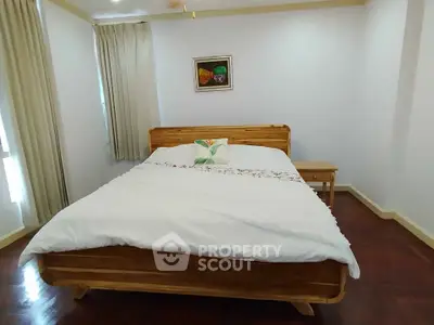 Cozy bedroom with wooden bed frame and elegant decor