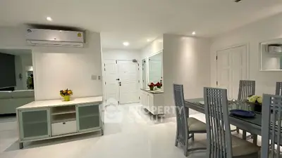 Spacious modern dining area with sleek furniture and bright lighting in a contemporary apartment.