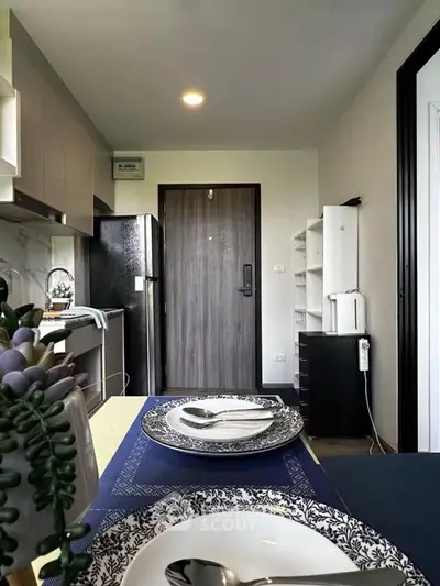Modern kitchen with open layout and stylish decor, featuring elegant dining setup and sleek appliances.